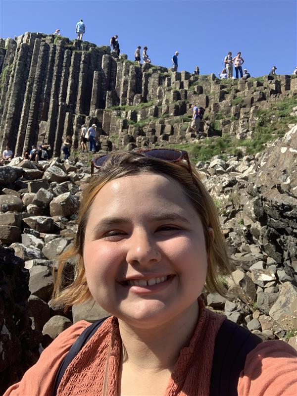 woman in front of rocks